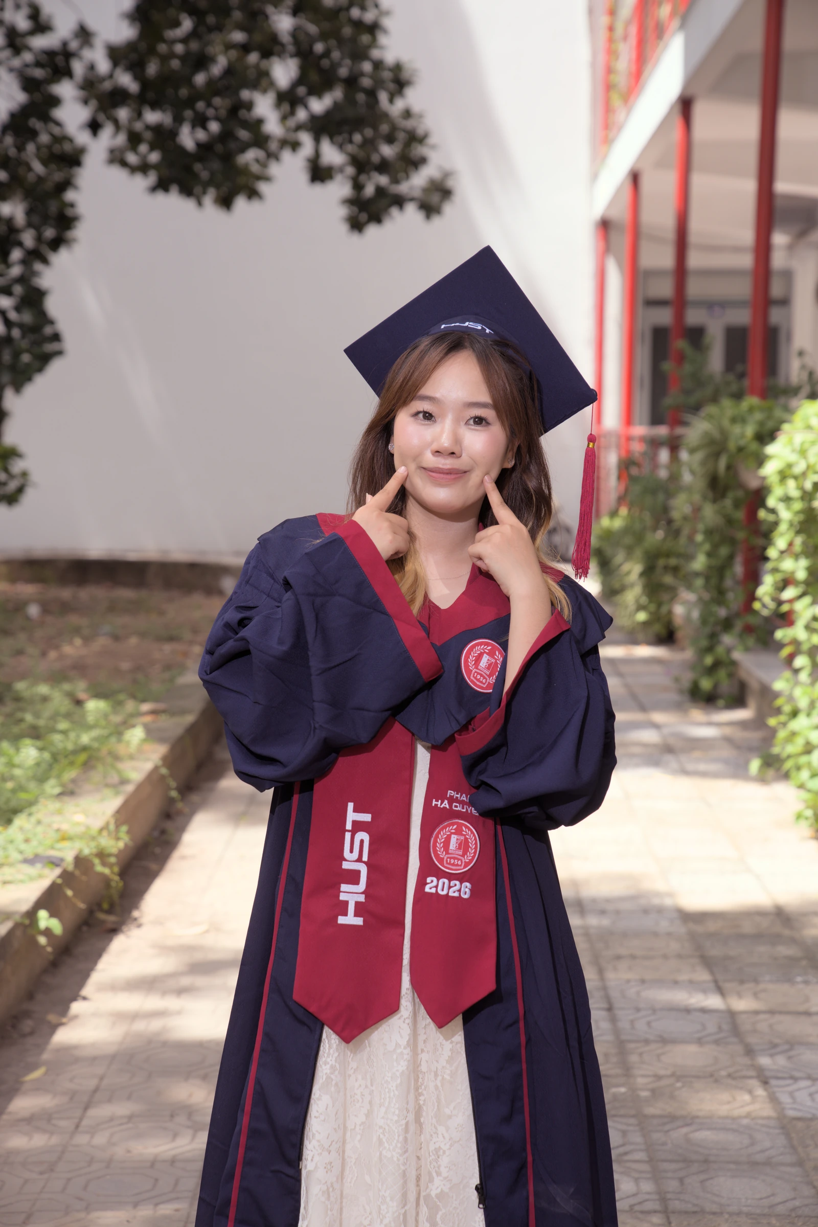 Quyên smiling in her graduation outfit